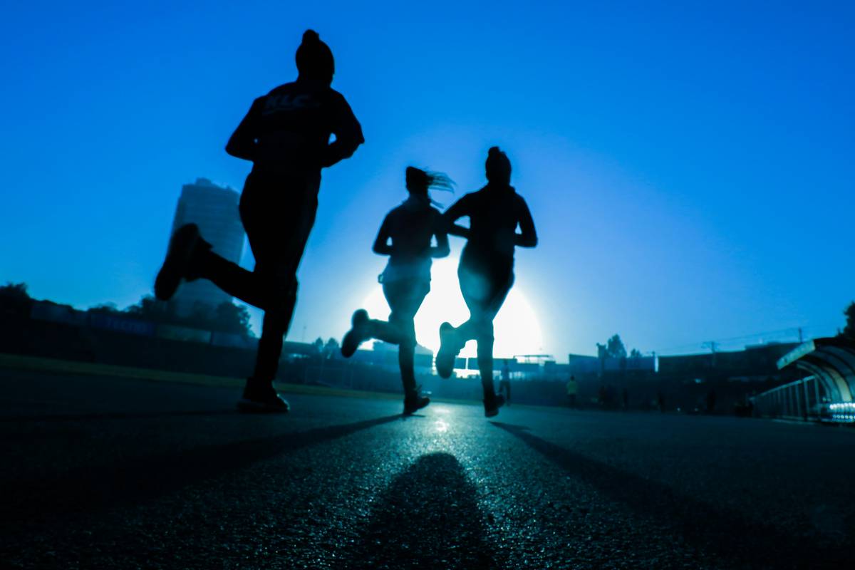 Beginner runner demonstrating proper form on trail showing what type of fitness is running involves full-body engagement